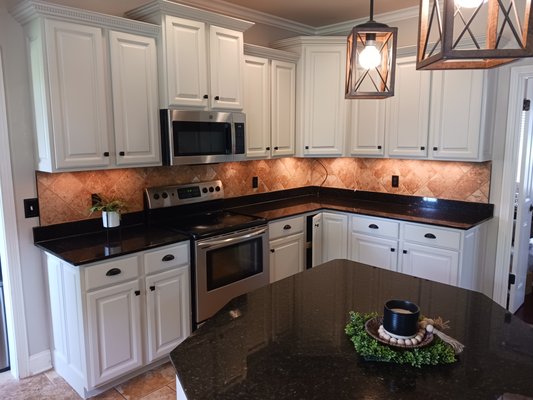 Kitchen Cabinet Makeover - Newburgh - This project involved refinishing a full set of kitchen cabinets for a homeowner who wanted a clean, refreshed look without the cost of a full replacement. While the cabinets were in generally good shape, a few areas required special attention—particularly a cabinet door above the stove that had been damaged by years of exposure to steam and h, and another door that had a visible crack.
To ensure a durable, long-lasting finish, we followed a thorough prep and painting process. We began by protecting the floors and surrounding surfaces, then carefully removed and labeled each door, drawer front, and piece of hardware to keep everything organized. After cleaning all surfaces with a gentle detergent—and using stronger products like Krud Kutter on tough spots—we lightly sanded to ensure good adhesion. Once the surfaces were clean and smooth, we applied a shellac-based primer to all cabinets for added protection, especially important in a high-moisture environment like a kitchen. We finished the job with two coats of Emerald Urethane Trim Enamel from Sherwin-Williams in a satin sheen, using the soft, warm tone of Accessible Beige (SW7036) for a clean and modern look. To ensure a silky-smooth finish, the primer and the first coat of paint was followed by light sanding to create a silky-smooth. Along the way, we made sure to address any drips or built-up areas.
The homeowner also requested updated cabinet hardware, which we were happy to take care of during reassembly.
In all, this was a large and challenging project, but the end result was worth the effort!! The cabinets now look beautifully refreshed and add warmth and sophistication to the entire kitchen...and all for way less than a complete kitchen remodel would have cost!! Kitchen Cabinet Makeover - Newburgh - This project involved refinishing a full set of kitchen cabinets for a homeowner who wanted a clean, refreshed look without the cost of a full replacement. While the cabinets were in generally good shape, a few areas required special attention—particularly a cabinet door above the stove that had been damaged by years of exposure to steam and h, and another door that had a visible crack.
To ensure a durable, long-lasting finish, we followed a thorough prep and painting process. We began by protecting the floors and surrounding surfaces, then carefully removed and labeled each door, drawer front, and piece of hardware to keep everything organized. After cleaning all surfaces with a gentle detergent—and using stronger products like Krud Kutter on tough spots—we lightly sanded to ensure good adhesion. Once the surfaces were clean and smooth, we applied a shellac-based primer to all cabinets for added protection, especially important in a high-moisture environment like a kitchen. We finished the job with two coats of Emerald Urethane Trim Enamel from Sherwin-Williams in a satin sheen, using the soft, warm tone of Accessible Beige (SW7036) for a clean and modern look. To ensure a silky-smooth finish, the primer and the first coat of paint was followed by light sanding to create a silky-smooth. Along the way, we made sure to address any drips or built-up areas.
The homeowner also requested updated cabinet hardware, which we were happy to take care of during reassembly.
In all, this was a large and challenging project, but the end result was worth the effort!! The cabinets now look beautifully refreshed and add warmth and sophistication to the entire kitchen...and all for way less than a complete kitchen remodel would have cost!!