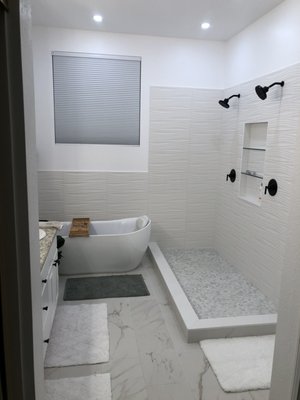 Bathroom Remodel - We removed the existing shower, tub, makeup vanity, and drywall and started brand new. We elongated the shower, created a new shower niche with glass shelving, and put in a stand alone tub with a wall mounted spout. Bathroom Remodel - We removed the existing shower, tub, makeup vanity, and drywall and started brand new. We elongated the shower, created a new shower niche with glass shelving, and put in a stand alone tub with a wall mounted spout.