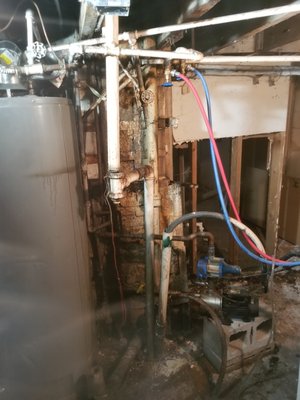 Prairie District High Rise Repipe/Repiping - This job was in the Praire District of Chicago.  A restoration company was involved helping us tear out all the walls due to water damage.  What was revealed behind the wall was horrible.  We had to change a water heater.  We had to run new drainage piping from the basement to the roof.  We had to repipe multiple existing water leaks.  We also installed a proper grey box as the one that was there was not up to code.