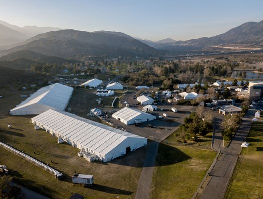 Tent Structures - Discover the impressive scale and beauty of our tenting solutions through ground and aerial views in our gallery. A1 PARTY RENTAL takes pride in offering large tent structures perfect for any event. From corporate events to lavish weddings, our tents are more than just coverings; they are architectural statements. These aerial shots capture the vastness and versatility of our inventory, highlighting how we can transform any space into an elegant, functional venue. Tent Structures - Discover the impressive scale and beauty of our tenting solutions through ground and aerial views in our gallery. A1 PARTY RENTAL takes pride in offering large tent structures perfect for any event. From corporate events to lavish weddings, our tents are more than just coverings; they are architectural statements. These aerial shots capture the vastness and versatility of our inventory, highlighting how we can transform any space into an elegant, functional venue.