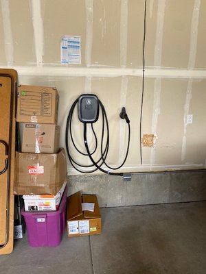 Acura EV charger Install - This was an Acura (Emporia) EV charger install inside a residential garage. The conduit was ran along the side of the house, below the siding (second picture), from the exterior main electrical panel to the garage.