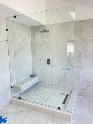 Glass Panels and Shelves - This one panel only shower enclosure is getting more and more popular. We put glass clamps to give the glass more strength and seal it with silicone.