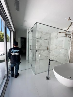 90⁰ Shower Door Installation - We installed this beautiful 90⁰ Glass-to-Glass door system in a master bedroom restroom. Our client knew exactly what they wanted and immediately presented us with their vision. Upon making our inclusions and reductions, we began to work accordingly. In the end, our client loved our work and has yet to call us for any issues or concerns regarding the shower. 90⁰ Shower Door Installation - We installed this beautiful 90⁰ Glass-to-Glass door system in a master bedroom restroom. Our client knew exactly what they wanted and immediately presented us with their vision. Upon making our inclusions and reductions, we began to work accordingly. In the end, our client loved our work and has yet to call us for any issues or concerns regarding the shower.