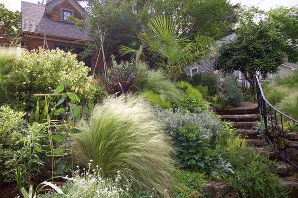 Tabor Home Gardens - Front and backyard transformations: rebuilding fence, stone retaining wall, plantings, drip irrigation, lawn, cedar arbor, and vegetable planters. Tabor Home Gardens - Front and backyard transformations: rebuilding fence, stone retaining wall, plantings, drip irrigation, lawn, cedar arbor, and vegetable planters.