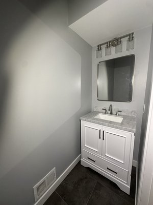 Half bath renovation - This half bathroom underwent a complete renovation, including the installation of new vinyl floor tiles for improved durability and appearance. All walls and the ceiling were prepped, repaired, and painted to refresh the space. A new toilet and vanity were installed for improved functionality, along with a recessed in-wall medicine cabinet for added storage. The project was finished with a new light fixture to enhance both lighting quality and overall aesthetics. Half bath renovation - This half bathroom underwent a complete renovation, including the installation of new vinyl floor tiles for improved durability and appearance. All walls and the ceiling were prepped, repaired, and painted to refresh the space. A new toilet and vanity were installed for improved functionality, along with a recessed in-wall medicine cabinet for added storage. The project was finished with a new light fixture to enhance both lighting quality and overall aesthetics.
