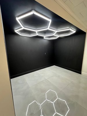 Modern Garage Redesign with Hexagonal LED Lighting - I completely repainted the room and the hallway, dividing the space into two contrasting zones: black and white. The black area serves as a visual accent and features a modular hexagon-shaped LED lighting system installed on the ceiling. I also prepared a dedicated space for motorcycle storage, ensuring both functionality and a modern, stylish look. Modern Garage Redesign with Hexagonal LED Lighting - I completely repainted the room and the hallway, dividing the space into two contrasting zones: black and white. The black area serves as a visual accent and features a modular hexagon-shaped LED lighting system installed on the ceiling. I also prepared a dedicated space for motorcycle storage, ensuring both functionality and a modern, stylish look.