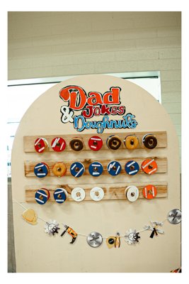Dad Joke Party! - Dad Joke Birthday Bash
This surprise party was punstoppable! We brought the dad jokes to life with a full red, white, and blue BBQ-themed setup, complete with a 5ft custom backdrop, balloon garland, donut wall, and sock-and-tie station. Guests competed in a “Best Dressed Dad” contest while laughing through a night full of dad jokes, brisket, and perfectly themed decor. Proof that a party doesn’t have to be serious to be seriously unforgettable.
