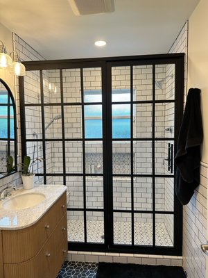 Bathroom Renovation Reveal - Transforming dreams into reality! This bathroom went from a classic tub to a stunning walk-in shower, and the results speak for themselves. Our team carefully designed every detail to create a modern, luxurious space featuring chic black-framed glass doors, a beautiful wood vanity, and eye-catching hexagonal floor tiles. The subway tile walls add a timeless touch, making this bathroom a perfect blend of style and function. Watch it to see the incredible before-and-after transformation! Bathroom Renovation Reveal - Transforming dreams into reality! This bathroom went from a classic tub to a stunning walk-in shower, and the results speak for themselves. Our team carefully designed every detail to create a modern, luxurious space featuring chic black-framed glass doors, a beautiful wood vanity, and eye-catching hexagonal floor tiles. The subway tile walls add a timeless touch, making this bathroom a perfect blend of style and function. Watch it to see the incredible before-and-after transformation!