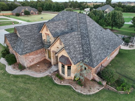 Final Result- Full Roof Refit - This is the final home of a multiple job site project in Piedmont, Ok, and it came out flawlessly. The previous brown/grey color of the roof dulled down the home's incredible look, but this new varied grey is an excellent compliment to an already modern home. Final Result- Full Roof Refit - This is the final home of a multiple job site project in Piedmont, Ok, and it came out flawlessly. The previous brown/grey color of the roof dulled down the home's incredible look, but this new varied grey is an excellent compliment to an already modern home.