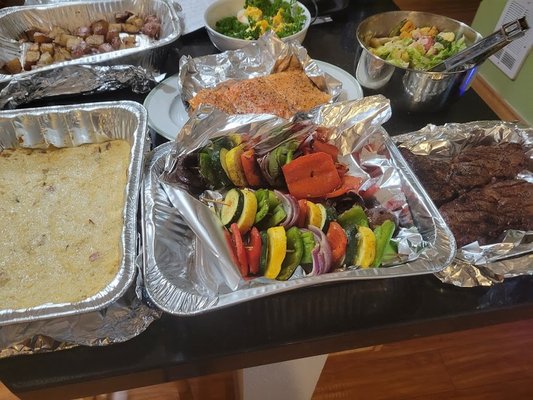 Celebration Of A Cat's Life Dinner for 5 - This client recently lost their cat and wanted to do something special with their family. They didn't want all the glitz and glam of nice dinnerware out but wanted a delicious grilled dinner. 3 Citrus and Herbed King Salmon Steaks for the ladies, and 2 black truffle ribeyes for the men. Accompanied with a fresh strawberry bacon salad, grilled lemon and dill veggies, creamy grits, some deviled eggs, and roasted potatoes. Humbly, I'll serve great food in foil pans and paper plates. Celebration Of A Cat's Life Dinner for 5 - This client recently lost their cat and wanted to do something special with their family. They didn't want all the glitz and glam of nice dinnerware out but wanted a delicious grilled dinner. 3 Citrus and Herbed King Salmon Steaks for the ladies, and 2 black truffle ribeyes for the men. Accompanied with a fresh strawberry bacon salad, grilled lemon and dill veggies, creamy grits, some deviled eggs, and roasted potatoes. Humbly, I'll serve great food in foil pans and paper plates.