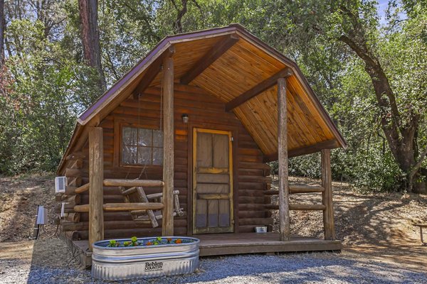 Cabins - No RV, no problem! Our cabins offer a rustic camping experience that reconnects you with nature. Our cabins provide A/C, electricity, mini fridge, microwave, flat screen TV, and Blu-Ray player. No charge to borrow Blu-Ray movies – we have hundreds to choose from. Cabins - No RV, no problem! Our cabins offer a rustic camping experience that reconnects you with nature. Our cabins provide A/C, electricity, mini fridge, microwave, flat screen TV, and Blu-Ray player. No charge to borrow Blu-Ray movies – we have hundreds to choose from.