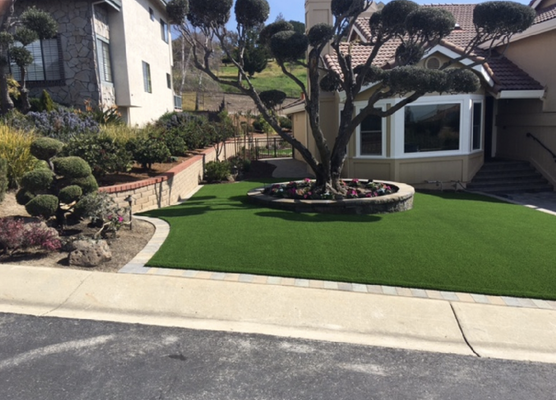 Artificial turf - Looking for a way to improve your home’s curb appeal? Or maybe you’re just looking for a way to make your backyard a more fun place to be? Artificial turf is perfect for those who are busy and on the go. With little to no maintenance required, you can spend more time with your family instead of worrying about your lawn. We install back yard artificial turf as well for putting greens or simply to give your lawnmower–and your back–a break. Artificial turf - Looking for a way to improve your home’s curb appeal? Or maybe you’re just looking for a way to make your backyard a more fun place to be? Artificial turf is perfect for those who are busy and on the go. With little to no maintenance required, you can spend more time with your family instead of worrying about your lawn. We install back yard artificial turf as well for putting greens or simply to give your lawnmower–and your back–a break.