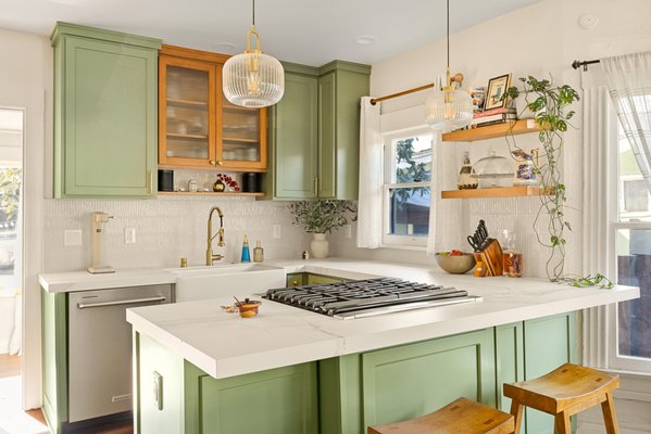 Kitchen + Bathroom Remodel Transformation by Dream Team Home Builders in La Habra, CA - When Dream Team Home Builders took on this Kitchen + Bathroom Remodel Transformation in La Habra, the goal was to create a cohesive upgrade that balanced warmth, character, and modern functionality throughout the home.
We began with a full kitchen renovation, introducing custom sage green shaker cabinetry paired with white quartz countertops and a waterfall island for a clean, seamless finish. Brass hardware and fixtures add contrast, while the farmhouse apron-front sink, glass pendant lighting, and open wood shelving bring texture and personality to the space. Warm wood flooring ties everything together, creating a kitchen that feels open, inviting, and built for daily use.
In the powder room, we installed a custom floating wood vanity with a vessel sink and brass faucet, complemented by bold coral wainscoting that adds depth and character. The full bathroom features a freestanding soaking tub, marble-top vanity, and a custom-tiled shower with a structured grid pattern and brass shower system, creating a balanced mix of clean lines and warm finishes.
By remodeling the kitchen and bathrooms at the same time, we maintained consistency in materials, color palette, and overall flow throughout the home. From demolition to final installation, our team handled every phase carefully to ensure a smooth build and a well-executed result.
If you’re planning a kitchen and bathroom remodel, Dream Team Home Builders is ready to take on your next project. Kitchen + Bathroom Remodel Transformation by Dream Team Home Builders in La Habra, CA - When Dream Team Home Builders took on this Kitchen + Bathroom Remodel Transformation in La Habra, the goal was to create a cohesive upgrade that balanced warmth, character, and modern functionality throughout the home.
We began with a full kitchen renovation, introducing custom sage green shaker cabinetry paired with white quartz countertops and a waterfall island for a clean, seamless finish. Brass hardware and fixtures add contrast, while the farmhouse apron-front sink, glass pendant lighting, and open wood shelving bring texture and personality to the space. Warm wood flooring ties everything together, creating a kitchen that feels open, inviting, and built for daily use.
In the powder room, we installed a custom floating wood vanity with a vessel sink and brass faucet, complemented by bold coral wainscoting that adds depth and character. The full bathroom features a freestanding soaking tub, marble-top vanity, and a custom-tiled shower with a structured grid pattern and brass shower system, creating a balanced mix of clean lines and warm finishes.
By remodeling the kitchen and bathrooms at the same time, we maintained consistency in materials, color palette, and overall flow throughout the home. From demolition to final installation, our team handled every phase carefully to ensure a smooth build and a well-executed result.
If you’re planning a kitchen and bathroom remodel, Dream Team Home Builders is ready to take on your next project.