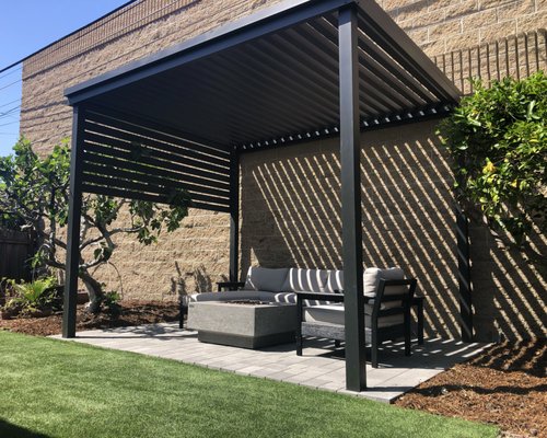 Pergola w/ Drop-Down Privacy Shade Wall - Long Beach - Introducing our meticulously constructed pergola with a versatile drop-down privacy shade wall, a harmonious blend of sophistication and functionality for your outdoor sanctuary. The thoughtfully designed structure combines aesthetic charm with robust durability, ensuring it stands the test of time.