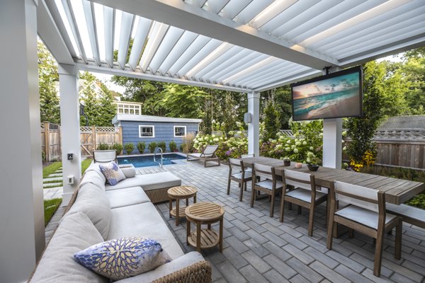 Luxurious & Cozy - Montclair, NJ - At the core of this transformative design lies the focal point of the plunge pool, which serves as
the heart and soul of the entire project. The client's desire for a compact, yet refreshing
cooling-off spot within their modest backyard was the driving force behind our creative vision.
The pool is not merely a visual feature, but a sanctuary, integrated into the landscape to provide
both relaxation and practicality in a confined space. Encircled by an elegant privacy fence, it
offers a sense of seclusion.
Bluestone stepping stones thoughtfully connect the house to the plunge pool, creating a
seamless transition from indoor to outdoor living. These stones guide the way to a small,
elevated patio, enclosed by a matching fence that not only ensures privacy but also adds to the
overall visual unity of the space.
Completing this backyard is a louvered pergola and an inviting sitting area, elevating the entire
setting to a true outdoor haven. This project demonstrates space-saving designs that combine
aesthetics, practicality, and tranquility. Luxurious & Cozy - Montclair, NJ - At the core of this transformative design lies the focal point of the plunge pool, which serves as
the heart and soul of the entire project. The client's desire for a compact, yet refreshing
cooling-off spot within their modest backyard was the driving force behind our creative vision.
The pool is not merely a visual feature, but a sanctuary, integrated into the landscape to provide
both relaxation and practicality in a confined space. Encircled by an elegant privacy fence, it
offers a sense of seclusion.
Bluestone stepping stones thoughtfully connect the house to the plunge pool, creating a
seamless transition from indoor to outdoor living. These stones guide the way to a small,
elevated patio, enclosed by a matching fence that not only ensures privacy but also adds to the
overall visual unity of the space.
Completing this backyard is a louvered pergola and an inviting sitting area, elevating the entire
setting to a true outdoor haven. This project demonstrates space-saving designs that combine
aesthetics, practicality, and tranquility.