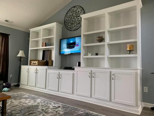 Custom Entertainment Center Build 14' by 8' - The client wanted a custom entertainment center to fit a record player that was at least 60 years old (far left). We measured twice and made sure we were perfect with the record player, albums, and the space to hand the television. Over 90 man hours in this beautiful job.