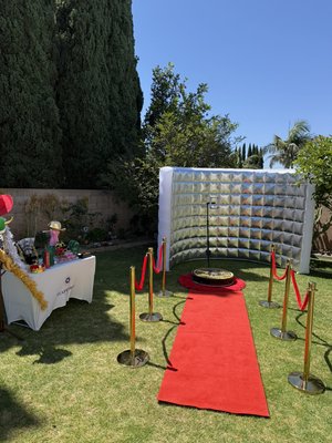 360 Photo Booth Vibes - This eye-catching 360 photo booth setup by Flash Folio Booth brings red carpet glam to any outdoor event. Complete with a custom LED inflatable backdrop, rotating 360 camera platform, gold stanchions with red ropes, and a vibrant table of photo booth props, this layout delivers a VIP experience for guests. Perfect for weddings, birthdays, and private parties across Orange County and Southern California. 360 Photo Booth Vibes - This eye-catching 360 photo booth setup by Flash Folio Booth brings red carpet glam to any outdoor event. Complete with a custom LED inflatable backdrop, rotating 360 camera platform, gold stanchions with red ropes, and a vibrant table of photo booth props, this layout delivers a VIP experience for guests. Perfect for weddings, birthdays, and private parties across Orange County and Southern California.
