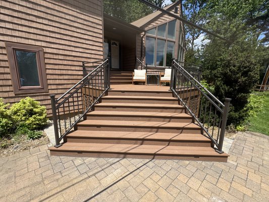 Maintenance-free Outdoor Entrance Improvement - 𝗣𝗥𝗢𝗕𝗟𝗘𝗠: The front steps and porch had an interesting shape and style, but the old, treated, and stained lumber was deteriorating and needed power washing and staining every few years. 𝗦𝗢𝗟𝗨𝗧𝗜𝗢𝗡: Replace decking, steps, and handrails with maintenance-free options while maintaining the home's visual appeal and featuring TREX lumber and iron railings. Maintenance-free Outdoor Entrance Improvement - 𝗣𝗥𝗢𝗕𝗟𝗘𝗠: The front steps and porch had an interesting shape and style, but the old, treated, and stained lumber was deteriorating and needed power washing and staining every few years. 𝗦𝗢𝗟𝗨𝗧𝗜𝗢𝗡: Replace decking, steps, and handrails with maintenance-free options while maintaining the home's visual appeal and featuring TREX lumber and iron railings.