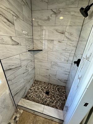 Bathroom Reno October 2024 - We completely transformed a pre-demoed space into a stunning, functional shower! The project started with a bare room, where we installed a drywall and applied a waterproof membrane to ensure long-term durability and a water-tight barrier. We did remove some of the wall under the window to allow for more space, this area was filled in with the same tile on the floor of the shower. We then laid down beautiful, meticulously aligned tiles and finished with grout for a seamless look. A custom-built shelf was also added for additional storage. On top of that, we upgraded the plumbing to accommodate the new design, including a new shower valve. Whether you're dreaming of a bathroom renovation or need help with tiling, waterproofing, or custom features, I'm here to bring your vision to life! Please note the customer opted to paint the walls. Bathroom Reno October 2024 - We completely transformed a pre-demoed space into a stunning, functional shower! The project started with a bare room, where we installed a drywall and applied a waterproof membrane to ensure long-term durability and a water-tight barrier. We did remove some of the wall under the window to allow for more space, this area was filled in with the same tile on the floor of the shower. We then laid down beautiful, meticulously aligned tiles and finished with grout for a seamless look. A custom-built shelf was also added for additional storage. On top of that, we upgraded the plumbing to accommodate the new design, including a new shower valve. Whether you're dreaming of a bathroom renovation or need help with tiling, waterproofing, or custom features, I'm here to bring your vision to life! Please note the customer opted to paint the walls.