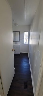 Bathroom Remodel - This bathroom was in dire need of a renovation. From old cabinets and carpeted floors, it all had to go. We brought a modern touch with a dark floor to compliment the pure white look of the walls and sink. We specialize in remodels of all kinds!
