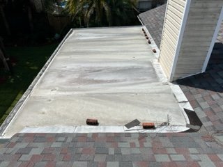 Reflash around a leaking patio cover - The homeowner had a roof replaced by another roofing company.  The flashing surrounding the patio cover was not addressed allowing water to leak down the walls.  We removed the old flashing, installed new flashing and extended the shingles to allow for proper drainage.
