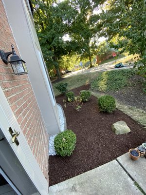 Mulch bed with Marble Rock! Also bush trimming! - We leveled out the area a little bit and added mulch with a touch of rock by the house for drainage / looks! We also trimmed all the baby bushes, front and back!