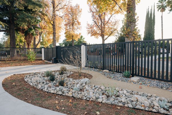 Water Wise Garden-Lake Balboa - We installed this water wise garden with California friendly and native plants. The dry river creek will significantly reduce water runoff and recharge the ground water. Native plants will help reduce air pollution. This type of landscaping requires seasonal maintenance only. Drip irrigation was installed to supplement areas of the garden, along with a smart wifi controller to help shut off irrigation when not needed. Natural pathways and open space allow for easy walking along the property and areas to sit and enjoy nature. A double entry electrical gate, parcel box, ring camera and column lights enhance the curb appeal and security of this property.