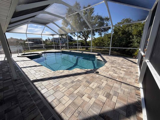 Pool Remodel in Apollo Beach - Full pool and spa remodel with new Flagstone Pavers City Stone Demi in White Tan Charcoal paver pool deck, bullnose coping, 1x2 mosaic tile, PebbleTec Pebblesheen Blue Granite pool finish, new pool waterfalls, new pool handrails, and new pool lighting.