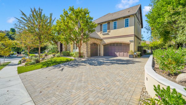 Full Front & Backyard Remodel- Calabasas Oaks - Luxurious pavers replacing an old driveway, lush artificial turf for evergreen lawns, garden walls accented with integrated lighting, enchanting stepping stones, a variety of plants, a custom paver patio, elegant walkways, and strategically placed spotlights to highlight the beauty. Full Front & Backyard Remodel- Calabasas Oaks - Luxurious pavers replacing an old driveway, lush artificial turf for evergreen lawns, garden walls accented with integrated lighting, enchanting stepping stones, a variety of plants, a custom paver patio, elegant walkways, and strategically placed spotlights to highlight the beauty.
