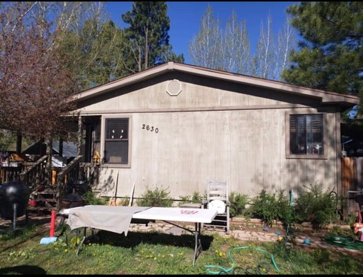 Exterior Paint Job - This house needed some love and now boasts a beautiful blue as the main color complemented with a crisp white trim with highlights around the windows that enhances the house's charm and curb appeal.
