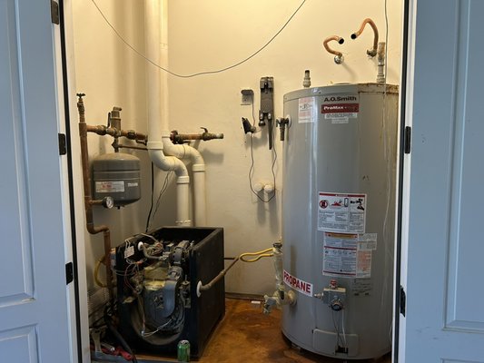 Combination tankless water heater and boiler - In this installation, we removed a 20-year-old 75 gallon water heater and boiler system. Then installed a single unit to take care of both the water heater and boiling system. These units allow for more space and efficiency. What makes these units more efficient is they only heat when demand is needed. It also adjusts the flame to meet heating requirements. This particular customer also requested a recirculation pump that he was able to control with his phone. These units come standard with this pump already in the unit. The customer wanted to forgo this to be able to control how much energy is being used. This installation was a couple day process due to how much demo that was needed and the amount of labor for all the different aspects involved. Combination tankless water heater and boiler - In this installation, we removed a 20-year-old 75 gallon water heater and boiler system. Then installed a single unit to take care of both the water heater and boiling system. These units allow for more space and efficiency. What makes these units more efficient is they only heat when demand is needed. It also adjusts the flame to meet heating requirements. This particular customer also requested a recirculation pump that he was able to control with his phone. These units come standard with this pump already in the unit. The customer wanted to forgo this to be able to control how much energy is being used. This installation was a couple day process due to how much demo that was needed and the amount of labor for all the different aspects involved.
