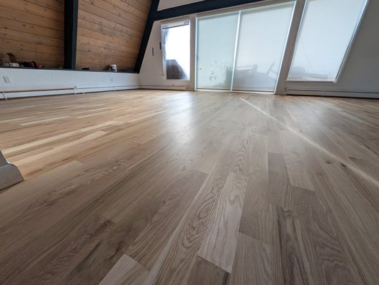 Evergreen Ponderosa Project - This mountain home’s recent renovation featured a comprehensive flooring transformation, seamlessly blending new additions with the home’s original character.
Scope of Work:
New Installations: Installed premium hardwood flooring across the first and second levels, along with a custom hardwood staircase.
Seamless Integration: Precision-patched existing hardwood to create a flawless transition between new and original spaces.
Full Refinishing: Sanded both new and old surfaces to a perfectly smooth finish.
Durable Protection: Applied a clear sealer followed by two coats of high-traffic finish to ensure long-lasting beauty and durability.
The project resulted in a stunning, unified look that left both the builder and homeowners delighted with the quality and finish. Evergreen Ponderosa Project - This mountain home’s recent renovation featured a comprehensive flooring transformation, seamlessly blending new additions with the home’s original character.
Scope of Work:
New Installations: Installed premium hardwood flooring across the first and second levels, along with a custom hardwood staircase.
Seamless Integration: Precision-patched existing hardwood to create a flawless transition between new and original spaces.
Full Refinishing: Sanded both new and old surfaces to a perfectly smooth finish.
Durable Protection: Applied a clear sealer followed by two coats of high-traffic finish to ensure long-lasting beauty and durability.
The project resulted in a stunning, unified look that left both the builder and homeowners delighted with the quality and finish.