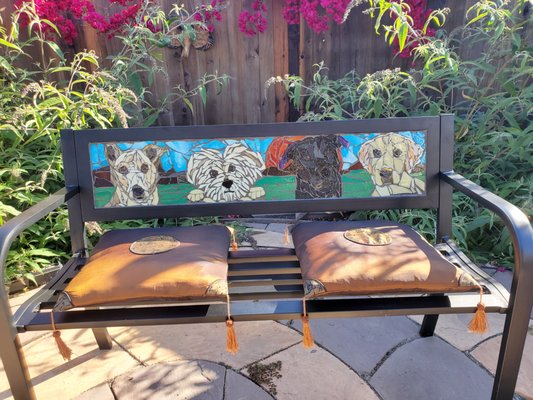 Custom Mosaic Patio Bench - This is a 45" iron bench with a custom glass mosaic built into the backrest. Using my client's photos, I created a mosaic of her 4 dogs and installed it onto the bench. Custom Mosaic Patio Bench - This is a 45" iron bench with a custom glass mosaic built into the backrest. Using my client's photos, I created a mosaic of her 4 dogs and installed it onto the bench.