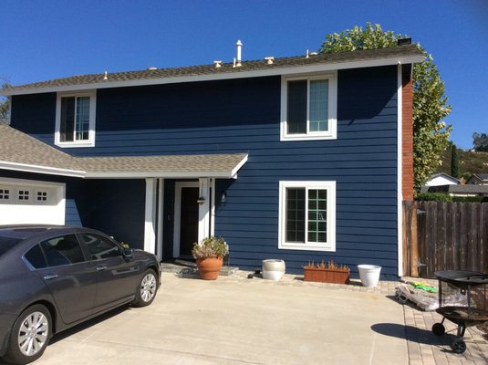 James Hardie Siding - San Diego - For this project, we installed James Hardie Plank Lap Siding on the front of the home to add some dimension. We then sealed it with a coating of LifePaint in a beautiful deep blue shade. Now the white windows contrast with the darker shade of the home, giving a sense of intentional design choice. We're in love with how this project turned out, and the homeowners love their new nautical vibes! James Hardie Siding - San Diego - For this project, we installed James Hardie Plank Lap Siding on the front of the home to add some dimension. We then sealed it with a coating of LifePaint in a beautiful deep blue shade. Now the white windows contrast with the darker shade of the home, giving a sense of intentional design choice. We're in love with how this project turned out, and the homeowners love their new nautical vibes!