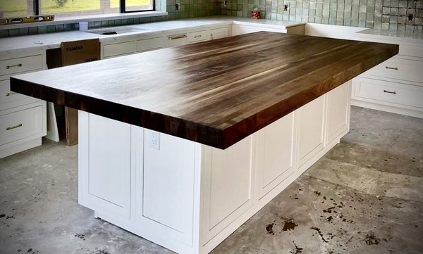 Custom Walnut Countertop + Kitchen Island - We worked with the client to design a their dream kitchen with access to storage at every turn, hand-picked finishes, customized paint colors, and designer hardware. 

The focal point of the kitchen was this BEAUTIFUL black walnut countertop, measuring 10' in total length, 5' wide, and a staggering 3.75" thick! ( over 700 lbs! )

Beauty and elegance was the final result.