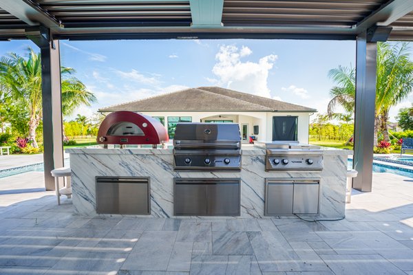 Dekton Kitchen Wrap - This kitchen & pergola created a custom outdoor living space, with retractable screens all around.
The entire structure was wrapped with a Dekton Material creating a modern & elegant look. Dekton Kitchen Wrap - This kitchen & pergola created a custom outdoor living space, with retractable screens all around.
The entire structure was wrapped with a Dekton Material creating a modern & elegant look.