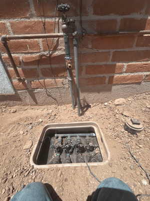 Irrigation Install, Valve Replacement - Rain Link Irrigation replaced and reconnected this irrigation valve system after the existing galvanized pipe was found connected to a heavily rusted and corroded line. Our crew carefully removed the old valves, carved out a small section of the footing, and connected the 3/4-inch pipe to the existing 1/2-inch galvanized pipe using a brass fitting. We then connected Schedule 80 pipe to the backflow assembly, installed and connected the valve box, restored the wiring, and repaired an additional leak in the backyard with a new cut and coupler. After testing the system, we completed a walkthrough with the customer, who was satisfied with the finished work.