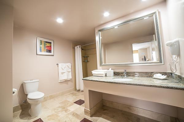Double Queen Bath - Our Double Queen rooms offer two queen size beds and up to 430 sq ft of space, with beautifully crafted natural stone bathrooms with a shower/tub combo. Perfect for traveling with family and friends. Each room comes standard with a 48" or 50" flat screen LED TV, Keurig coffee maker, electronic lock safe, refrigerator, Wi-Fi/Ethernet access, USB charging, desk and chair, and armchair. (Armchair not available in every room)