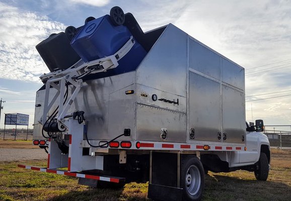 Trash Bin Cleaning - Our truck arrives at your house. The driver places the bins into the arms. The bins are lifted over the spray heads and the inside of the cans are cleaned. The driver then uses the pressure wand to clean the outside of the cans. The whole process is completed under 4 minutes. Trash Bin Cleaning - Our truck arrives at your house. The driver places the bins into the arms. The bins are lifted over the spray heads and the inside of the cans are cleaned. The driver then uses the pressure wand to clean the outside of the cans. The whole process is completed under 4 minutes.