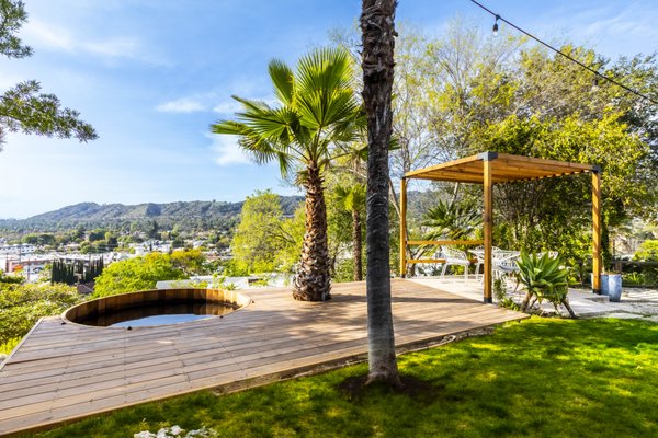 Create Your Hillside Retreat - This project features a custom-built redwood deck with a matching integrated hot tub, designed for both relaxation and visual continuity. A redwood pergola was added to provide shade and define the outdoor living space, using clean lines and durable materials.

We also installed a custom tile patio adjacent to the deck, offering a spacious and low-maintenance area for entertaining and family activities. The combination of wood and tile creates a balanced, functional layout that fits the client’s needs and complements the home’s exterior.

All elements were built to withstand year-round use while maintaining a clean, cohesive appearance.