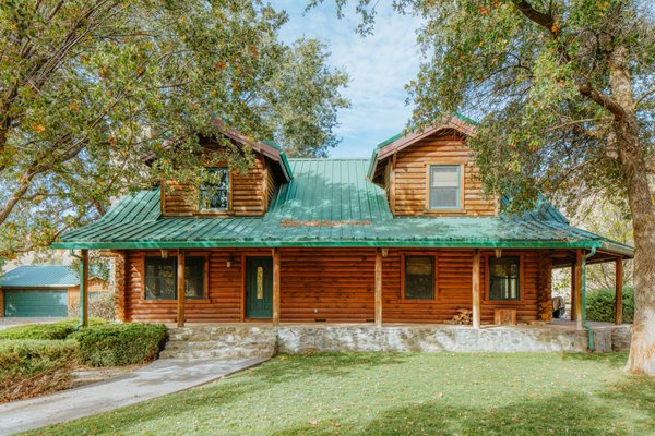 The Log Cabin - Welcome to your own "Ponderosa." A true log cabin, this 2,100 square foot, 3 bedroom, 2.5 bath home is cozy and spacious, sneaking views of the surrounding pastures and mountains. Taking you back in time, you'll enjoy sitting on the front porch, barbecuing in the backyard, and cozying up by the stone fireplace. You might even make a grass-fed friend!

Bedroom Breakdown
Bedroom #1: 1 king
Bedroom #2: 1 king
Bedroom #3: 2 sets of bunk beds (4 twins)

Amenities in the Log Cabin include: gas bbq, central air/heat, Apple HomePod, 55" Smart TV, wi-fi, full kitchen with dishes, cookware, and utensils, indoor fireplace (must bring your own wood), seating around the patio, fire pit (must bring your own wood), oven, gas range, refrigerator, fresh drinking water, toaster, coffee beans and grinder, coffee maker, salt/pepper, cooking oil, iron & ironing board, shampoo, liquid body wash, linens and towels, blow dryer, hand and dish soap, toilet paper, paper towels, trash bags, pac-n-play, washer and dryer, and more!
