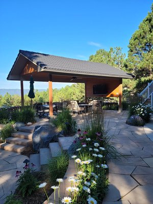 Outdoor Living and Entertaining at its Finest - Our customers wanted to design their backyard as a beautiful, relaxing oasis for outdoor entertaining.  DBS worked with them and designed a ramada (patio cover) that would allow them to create the space they envisioned.  We built a free-standing, gabled roof patio cover with a half-wall on one end.  The ceiling is vaulted tongue and groove pine with recessed lighting and a ceiling fan.  Since we had to add electricity for the lights and fan, we also added outlets in the Cedar half-wall and on the two support posts closest to the house.  This allowed the homeowners to mount a TV on the half-wall.  The roofing tile is the same style as those on the house.  The existing deck did not have a staircase leading down to the backyard, so we built one with a 90-degree turn landing to minimize the footprint of the stairs.  The railing is a Fortress AL-13 aluminum railing in white.