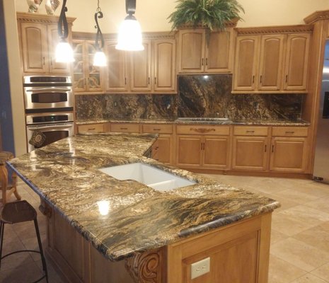 Kitchen Remodel – Magma Gold Granite Countertops - This kitchen was fully updated to match the rest of the home, featuring new cabinetry, appliances, and custom 3cm Magma Gold granite countertops. We installed a full backsplash and island, highlighting the natural gold and black movement of the stone.

The result is a warm, cohesive space with durable, high-quality surfaces designed for everyday use and long-term beauty.