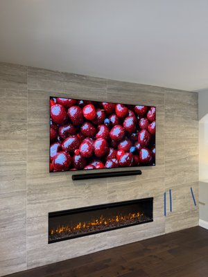 TV Installation + Soundbar Installation above fireplace on tile wall - TV Installation + Soundbar Installation above fireplace on tile wall