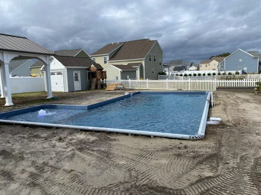 New Pool Builds - Our experienced team is equipped to assist you through every stage of pool construction in Hampton Roads. If you are excited about the possibility of new pool construction at your home, you should turn to us at Legacy Pools. To ensure that you get the swimming pool you have imagined. There are many stages required during pool construction, and our experienced team is equipped to assist you from design through completed installation.
Pool construction is typically completed in the following phases:
Layout
Grading & Excavation
Installation of Wall Panels
Leveling and Staking of Panels
Pouring of Concrete Footer
Plumbing
Vermiculite Bottom Installation
Liner Installation
Fill with Water
Backfilling & Grading
Decking
When’s the best time to build a Pool?
You may not have considered it, but autumn is the best time of year to begin researching for a swimming pool construction project. Which means you should start thinking about what is on your pool construction wish list. Why? Because this time of year swimming pool contractors are not as busy, prices may be lower and before the winter season arrives, installing a swimming pool now means that it will be ready for you to swim as soon as the next pool season rolls around. New Pool Builds - Our experienced team is equipped to assist you through every stage of pool construction in Hampton Roads. If you are excited about the possibility of new pool construction at your home, you should turn to us at Legacy Pools. To ensure that you get the swimming pool you have imagined. There are many stages required during pool construction, and our experienced team is equipped to assist you from design through completed installation.
Pool construction is typically completed in the following phases:
Layout
Grading & Excavation
Installation of Wall Panels
Leveling and Staking of Panels
Pouring of Concrete Footer
Plumbing
Vermiculite Bottom Installation
Liner Installation
Fill with Water
Backfilling & Grading
Decking
When’s the best time to build a Pool?
You may not have considered it, but autumn is the best time of year to begin researching for a swimming pool construction project. Which means you should start thinking about what is on your pool construction wish list. Why? Because this time of year swimming pool contractors are not as busy, prices may be lower and before the winter season arrives, installing a swimming pool now means that it will be ready for you to swim as soon as the next pool season rolls around.