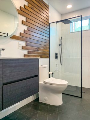 Bathroom Remodel - This was a hall bathroom remodel we completed in Roseville with a curbless tiled shower, niche with quartz shelves, floating vanity, LED mirror, heated towel bar, can lights, and awesome floor tile.