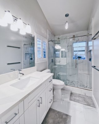 Alewa Heights Bathroom - The owner of this Alewa Heights home wanted to upgrade her bathroom to something sleek, modern, and bright. We completely gutted the existing shower and extended it across the length of the bathroom, adding useful features such as a sliding glass door, shower bench, soap niche, and rain shower hardware. Alewa Heights Bathroom - The owner of this Alewa Heights home wanted to upgrade her bathroom to something sleek, modern, and bright. We completely gutted the existing shower and extended it across the length of the bathroom, adding useful features such as a sliding glass door, shower bench, soap niche, and rain shower hardware.
