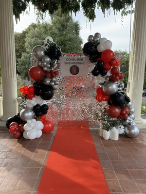 Netflix Corporate Event - This event was done for a team within Netflix. This event requested a backdrop for photos, table decor and a welcome sign. Backdrop includes an 8x8' silver shimmer wall complete with organic balloon garland, custom sign, greenery and red carpet. Table top balloon centerpieces were also used for dinging tables and mini balloon centerpieces were placed around cocktail tables. Welcome sign includes another custom sign, organic balloon garland and greenery as well placed upon our copper frame.