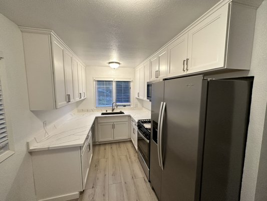 Kitchen remodeling - This remodel was done on old kitchen. New cabinets, new countertops, sink, faucet and other appliances, new luxury vinyl plank flooring. Came out great, client was really happy.