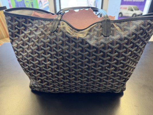 Goyard Saint Louis Tote: Makeup Stain Removed From the Canvas Lining - This Goyard Saint Louis tote (retails around $1,800) came in after a makeup compact opened inside it and soaked the cream canvas lining brown, while a chalky grey film had dulled the chevron canvas outside. A bag like this never goes in a machine at Baroni Cleaners. It is hand work on a spotting board start to finish. We spot-tested the lining to confirm it was colorfast, then broke the oil and lifted the pigment in stages with drying time between passes until the cream came back. The coated Goyardine outside got a separate gentle surface clean that lifted the film without abrading the chevron, and the leather trim was conditioned on its own. The matching pochette was cleaned alongside so the set came back consistent, and we finished the interior with a water-repellent coat so a future spill beads instead of soaking in. The lining reads cream again and the pattern reads sharp.

Free pickup and delivery across Irvine, Newport Beach, Tustin, Santa Ana and Costa Mesa. (949) 316-4276.